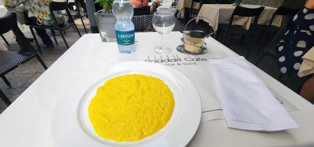 Risotto alla Milanese on a white plate at Caffè Spadari in Milan