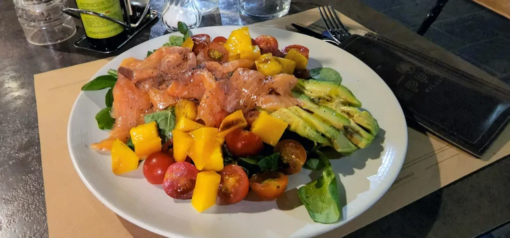 Vegetable salad with salmon and avocado at Eppol Milano in Milan