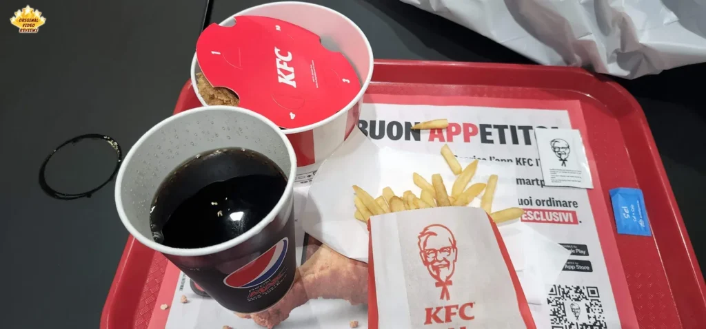 KFC personal bucket meal on a red tray with a free-refill drink at KFC Viale Abruzzi in Milan