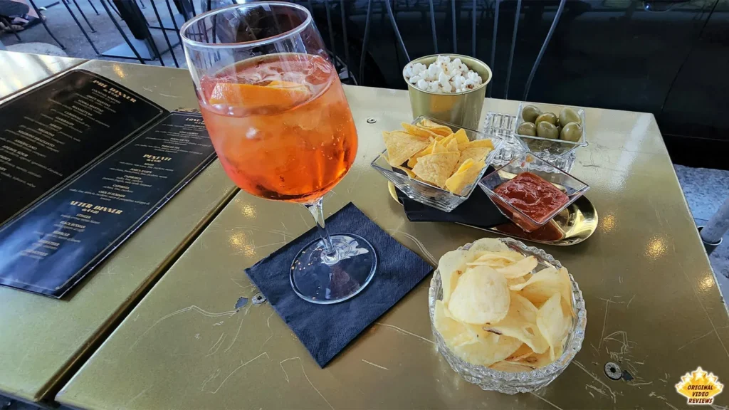 Aperol Spritz with aperitivo snacks on a table at Leccomilano in Milan
