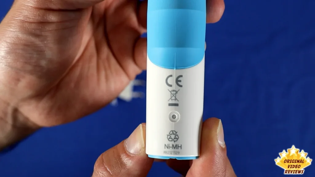Hand holding the bottom of the Oral-B Vitality handle showing the CE mark and printed label