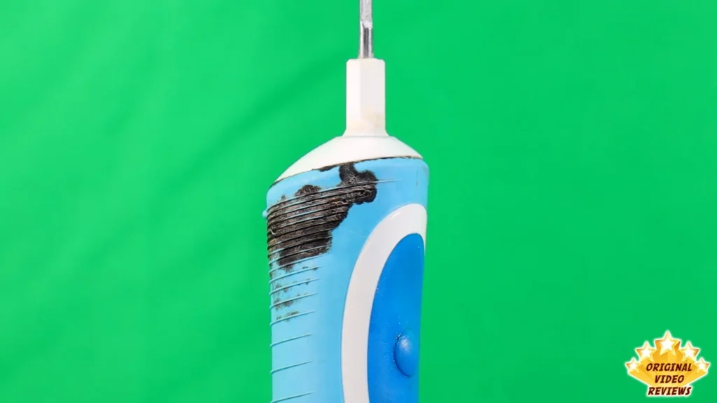 Old Oral-B Vitality handle with black mold on the lower part, green background