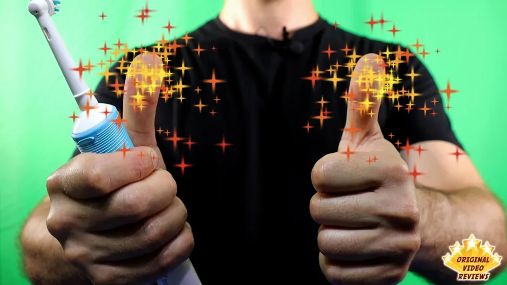 Person in a black shirt holding the Oral-B Vitality electric toothbrush with both thumbs up, green background with sparkle effect