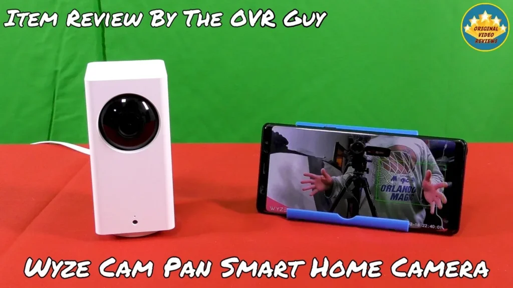 Camera next to a smartphone on a stand | Wyze Cam Pan